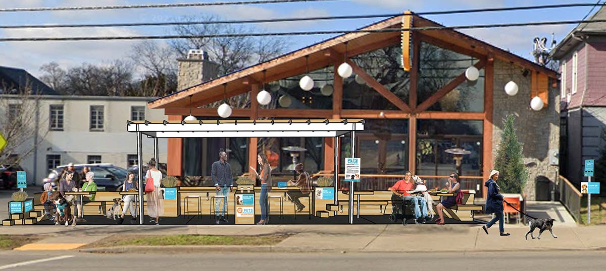 A rendering in which pet-friendly features have been added to a restaurant patio, including signs about responsible pet ownership, a pet drinking fountain and a waste bag dispenser