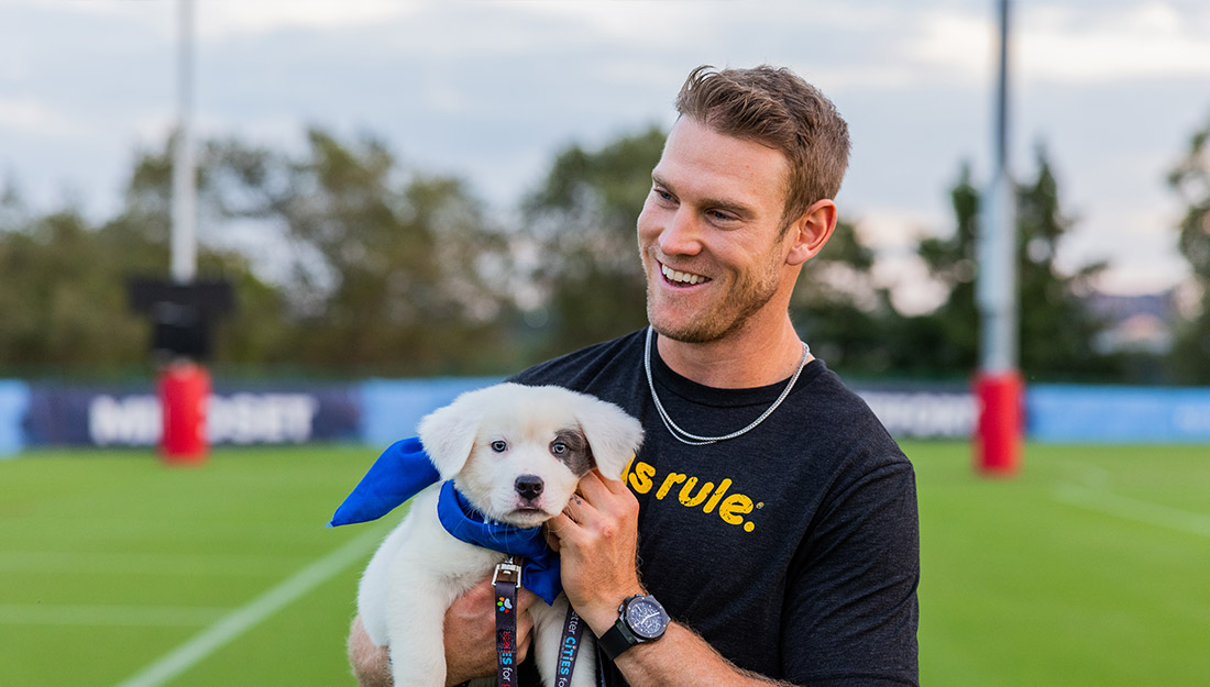 Tennessee Titans Quarterback Ryan Tannehill holding a puppy