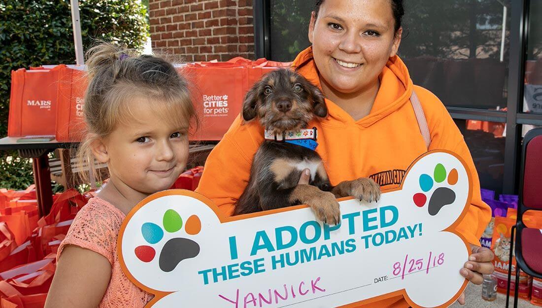 happy family with adopted pet|