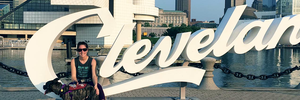 woman and dog by Cleveland sign|front of Cleveland Ohio animal kennel|adoptable dog at vegan market|Portrait of Mayor Frank G. Jackson|happy dog by Cleveland sign|woman and dog by Cleveland sign