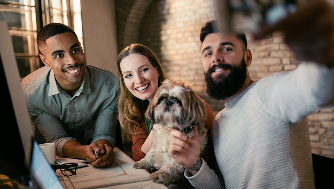 A group of adults and a dog